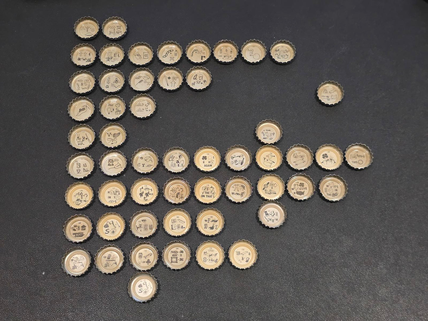 Set of 76 Lucky Lager Rebus/Puzzle Bottle Caps - Silver w/ Red Script