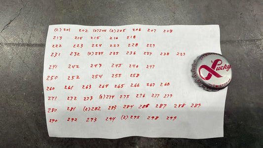 Set of 76 Lucky Lager Rebus/Puzzle Bottle Caps - Silver w/ Red Script