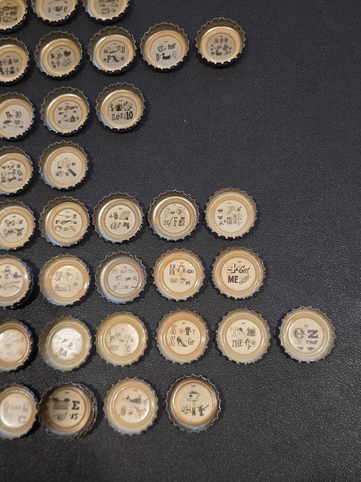 Set of 76 Lucky Lager Rebus/Puzzle Bottle Caps - Silver w/ Red Script