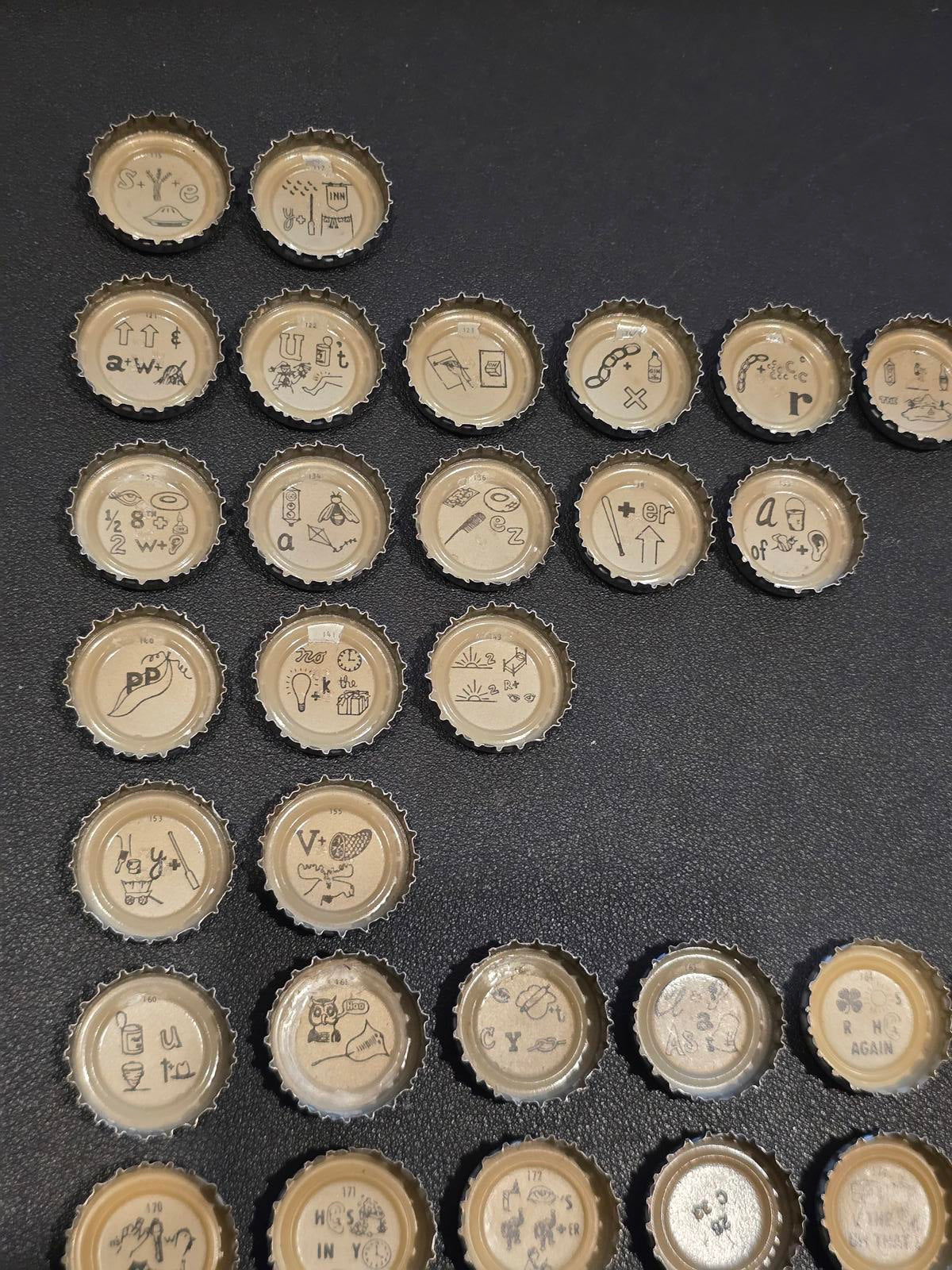 Set of 76 Lucky Lager Rebus/Puzzle Bottle Caps - Silver w/ Red Script