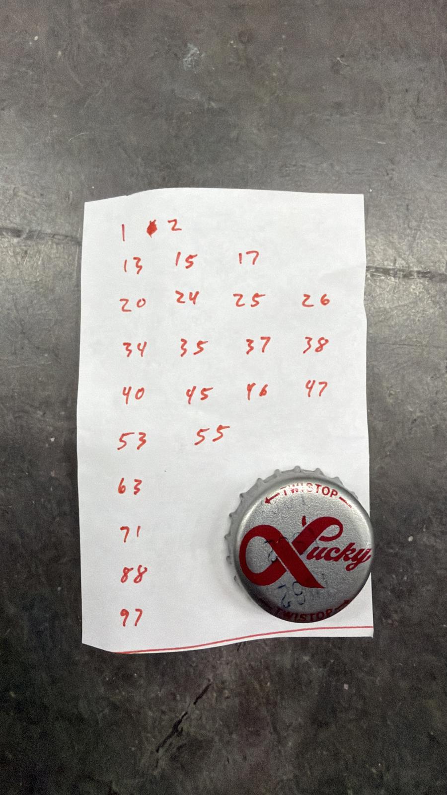 Set of 76 Lucky Lager Rebus/Puzzle Bottle Caps - Silver w/ Red Script