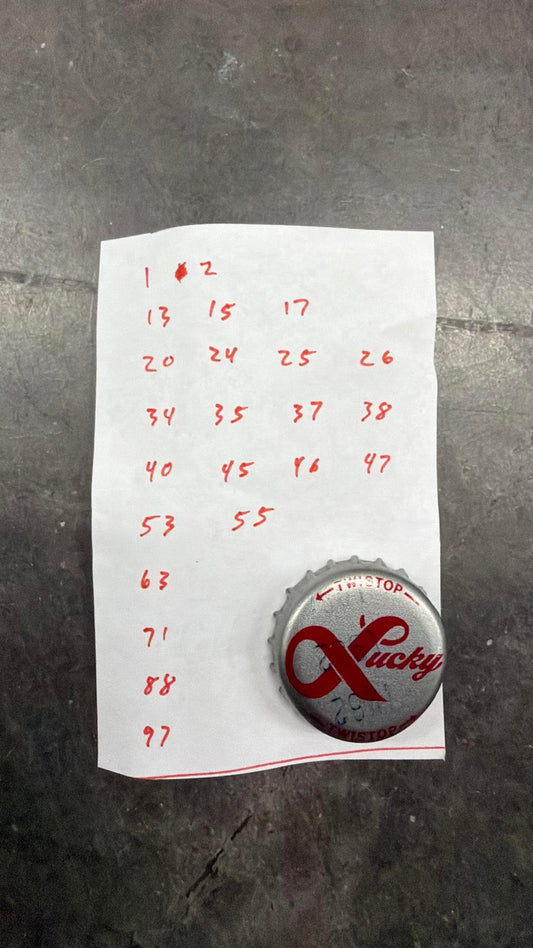 Set of 76 Lucky Lager Rebus/Puzzle Bottle Caps - Silver w/ Red Script