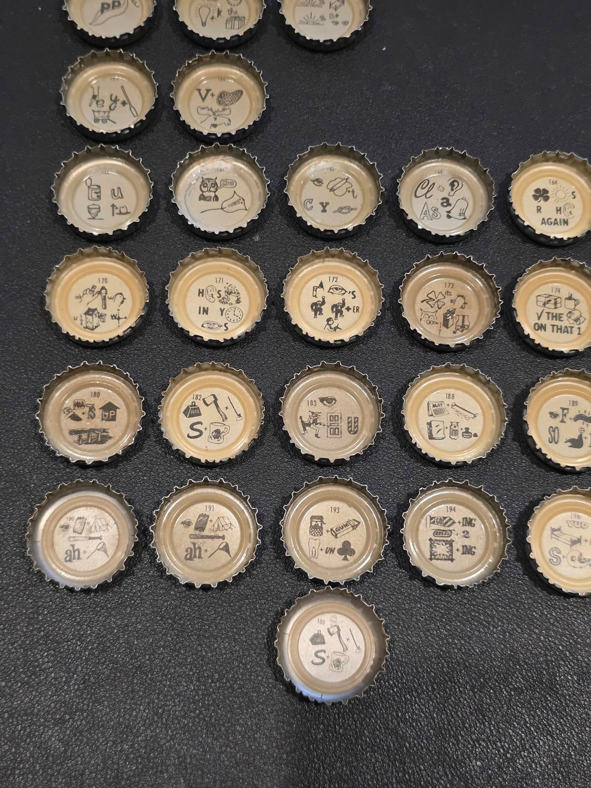 Set of 76 Lucky Lager Rebus/Puzzle Bottle Caps - Silver w/ Red Script