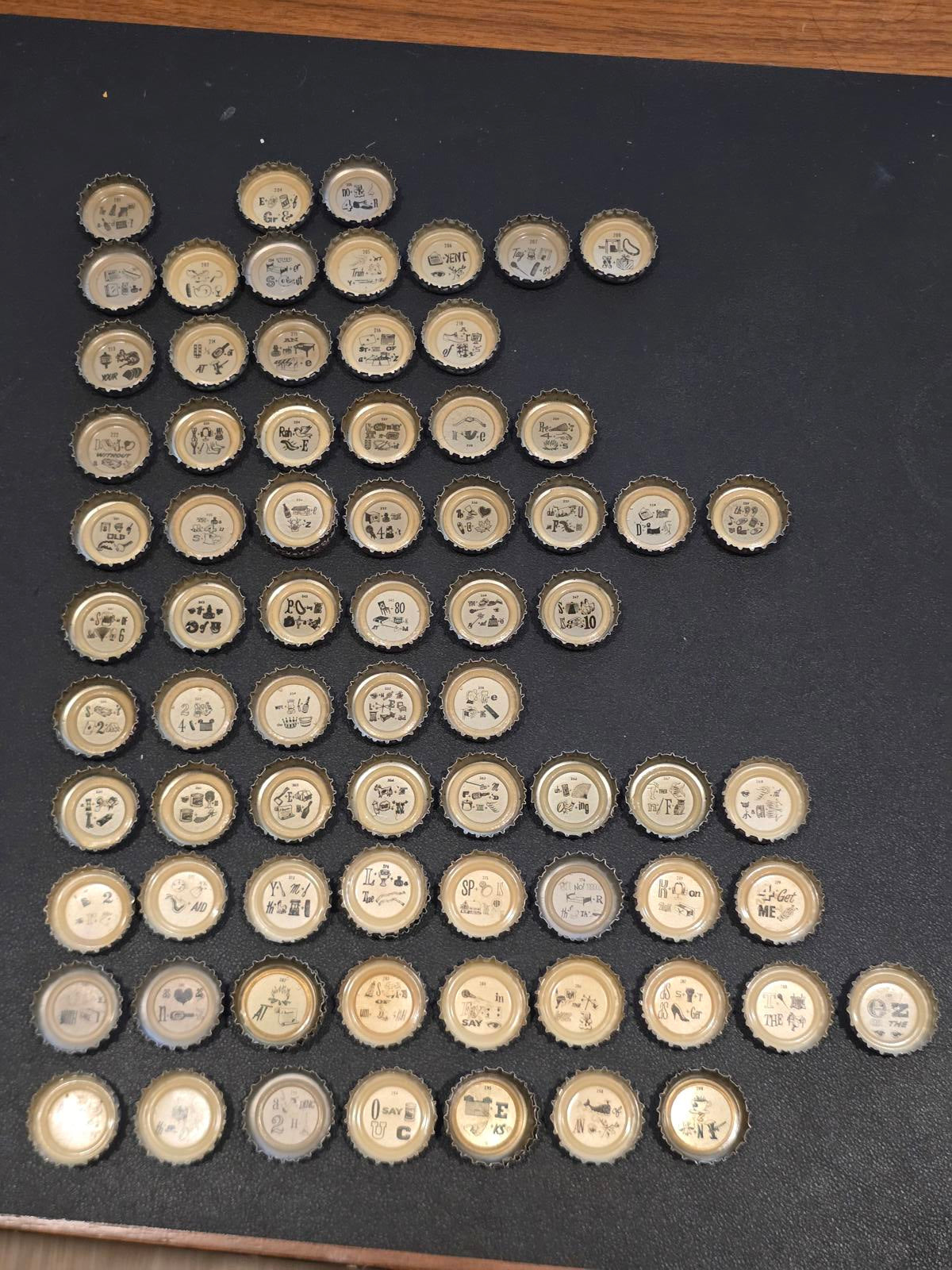 Set of 76 Lucky Lager Rebus/Puzzle Bottle Caps - Silver w/ Red Script