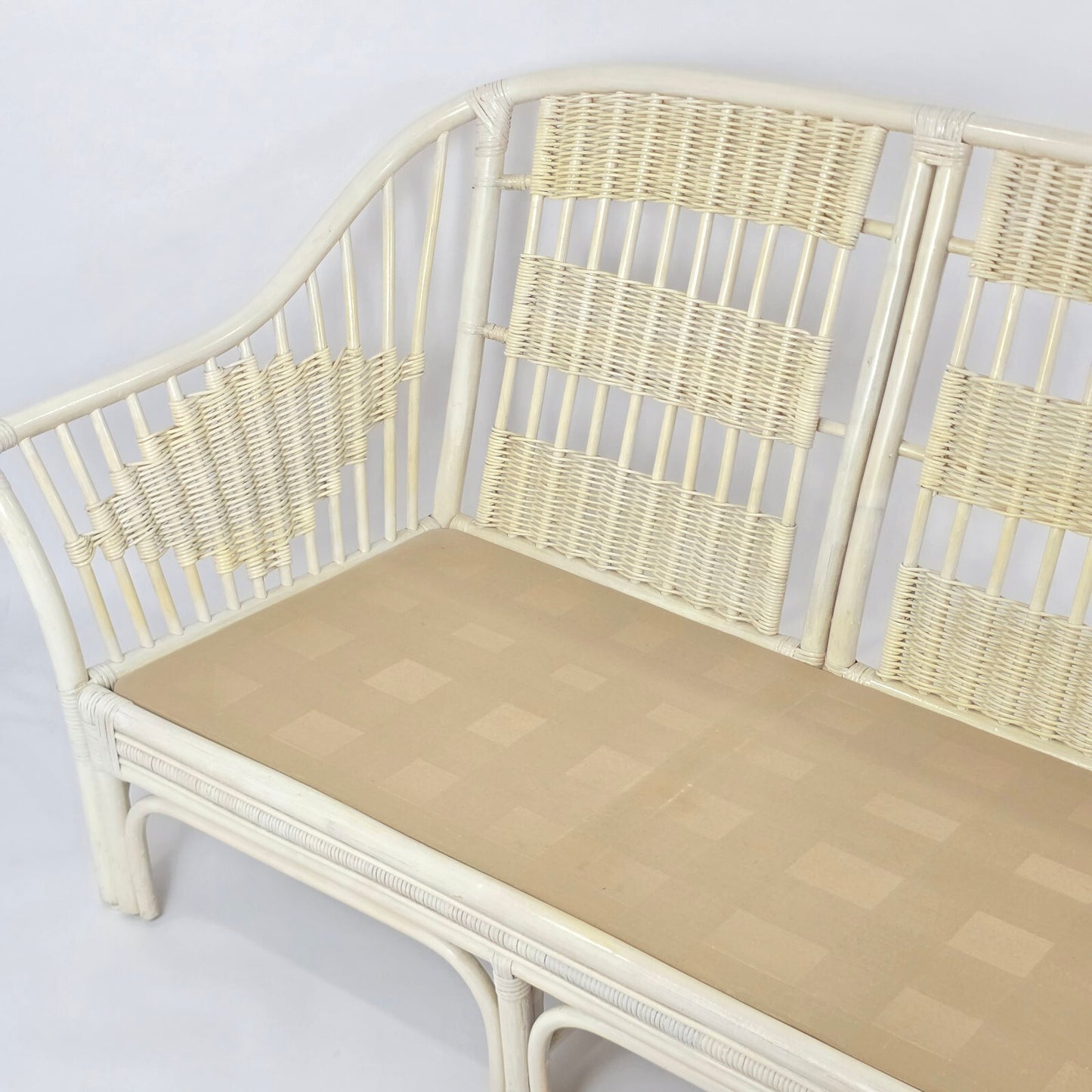 Whitewashed Rattan Sofa with Floral Cushions