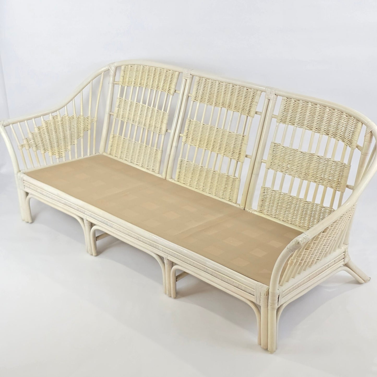 Whitewashed Rattan Sofa with Floral Cushions