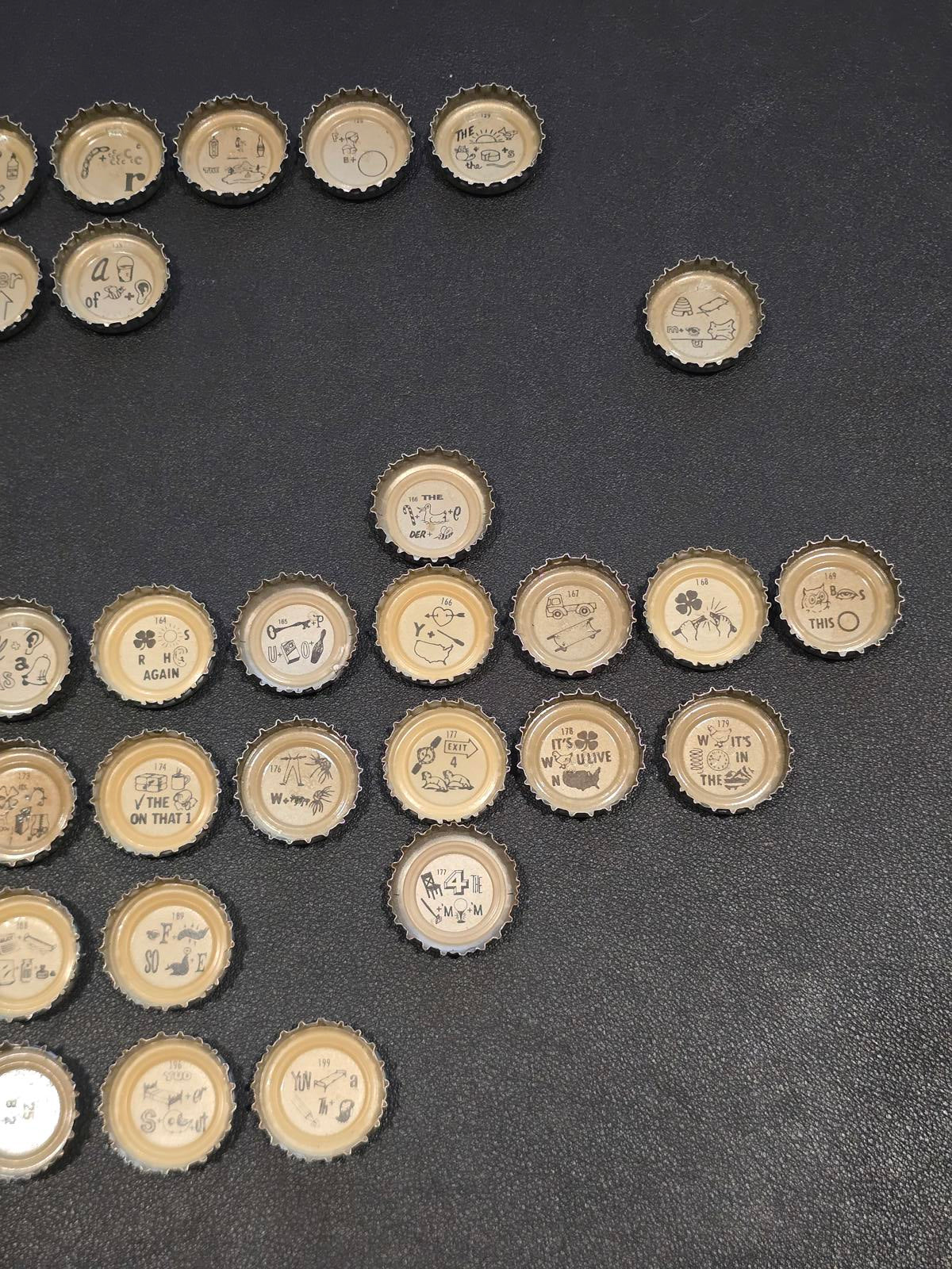 Set of 76 Lucky Lager Rebus/Puzzle Bottle Caps - Silver w/ Red Script