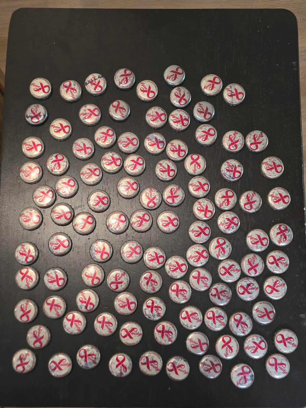 Set of 122 Lucky Lager Rebus/Puzzle Bottle Caps - Silver w/ Red Script